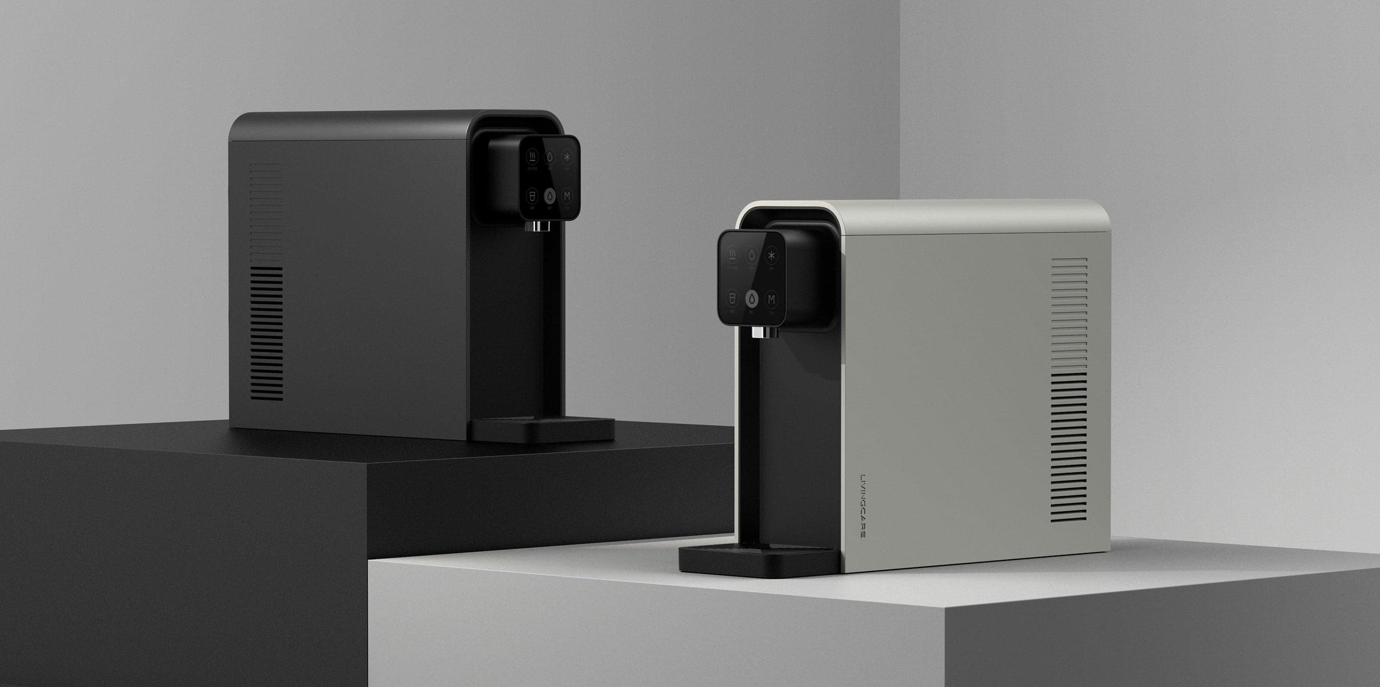 Livingcare black and sage water dispensers displayed in a studio